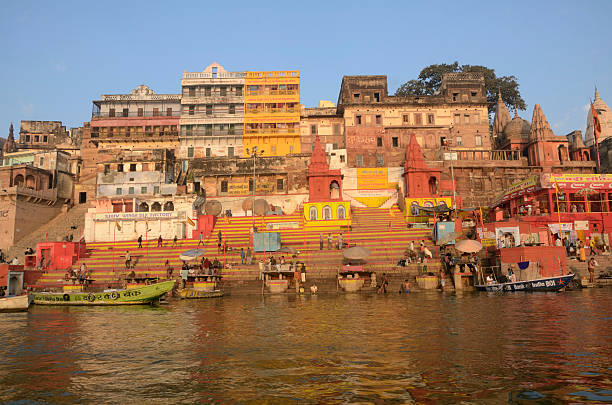 morning on ganges Varanasi, India - February 8, 2014: Prayer and worship on the Ganges, Varanasi. The City of Shiva is one of the holiest cities in India and Hindu pilgrims come to wash away their sins at a place where the physical and spiritual world meet. varanasi sare stock pictures, royalty-free photos & images